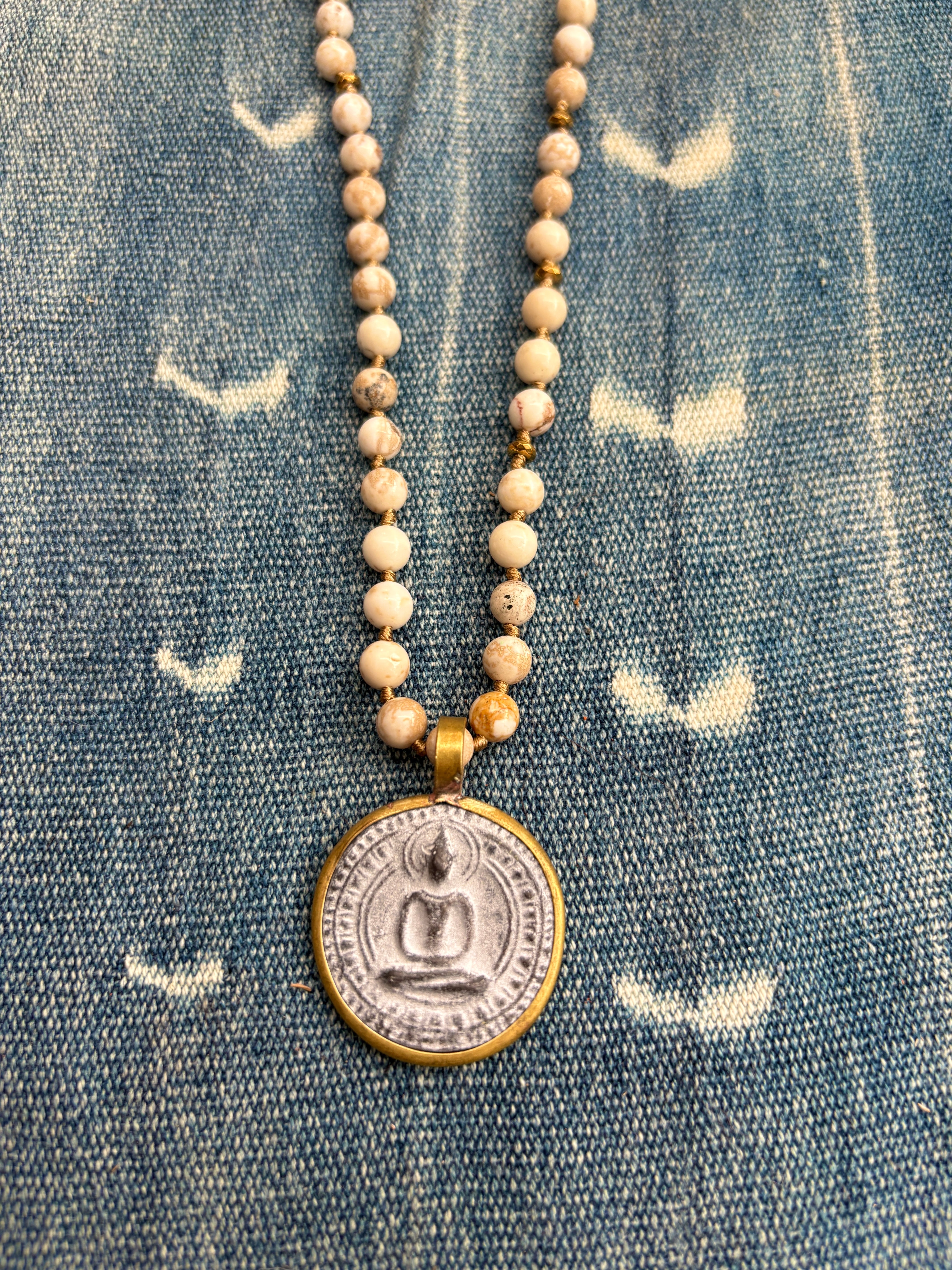 Necklace with a pendant on a denim background