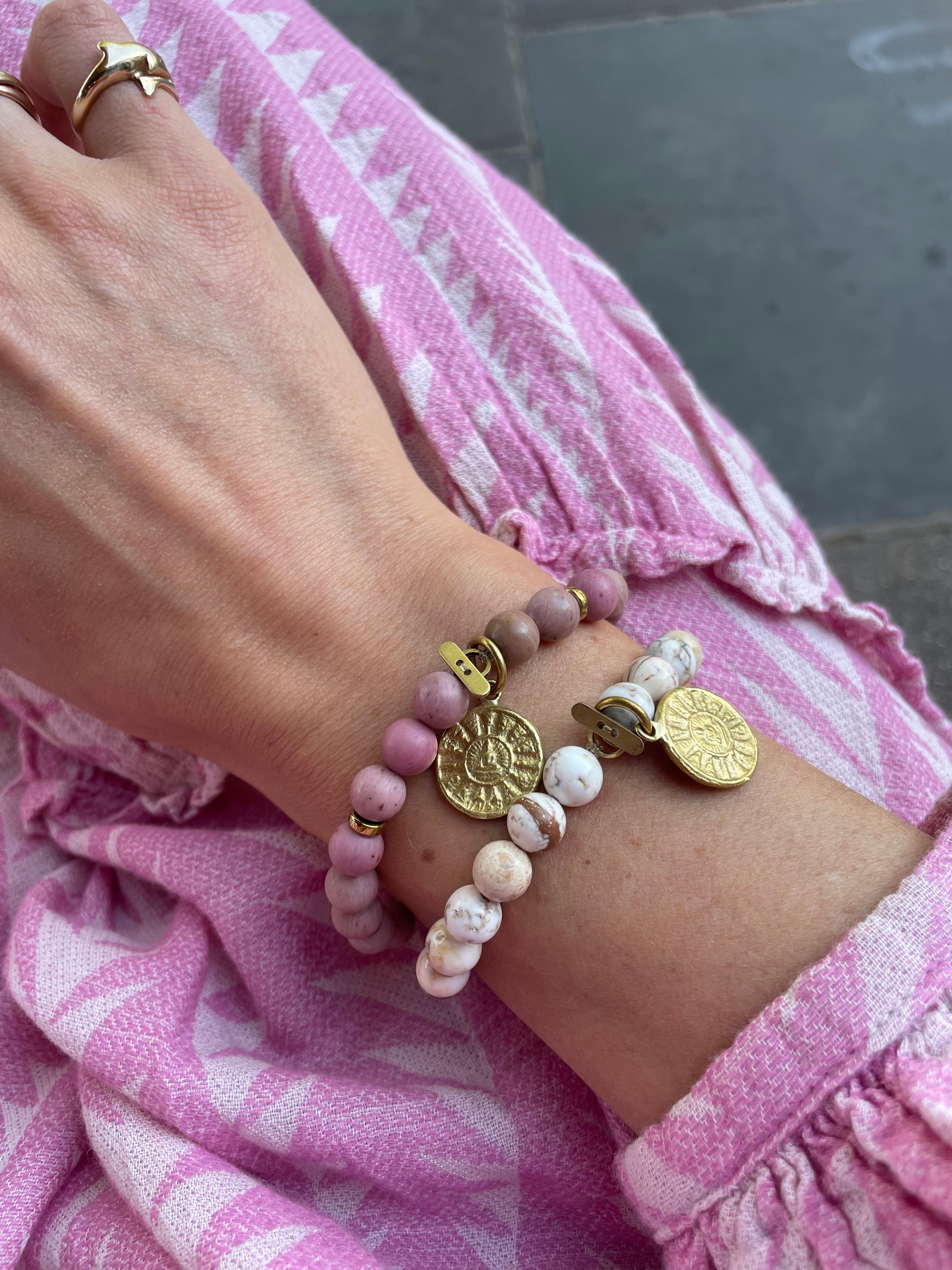 beaded bracelets pink stones white stones with sun medallion in gold
