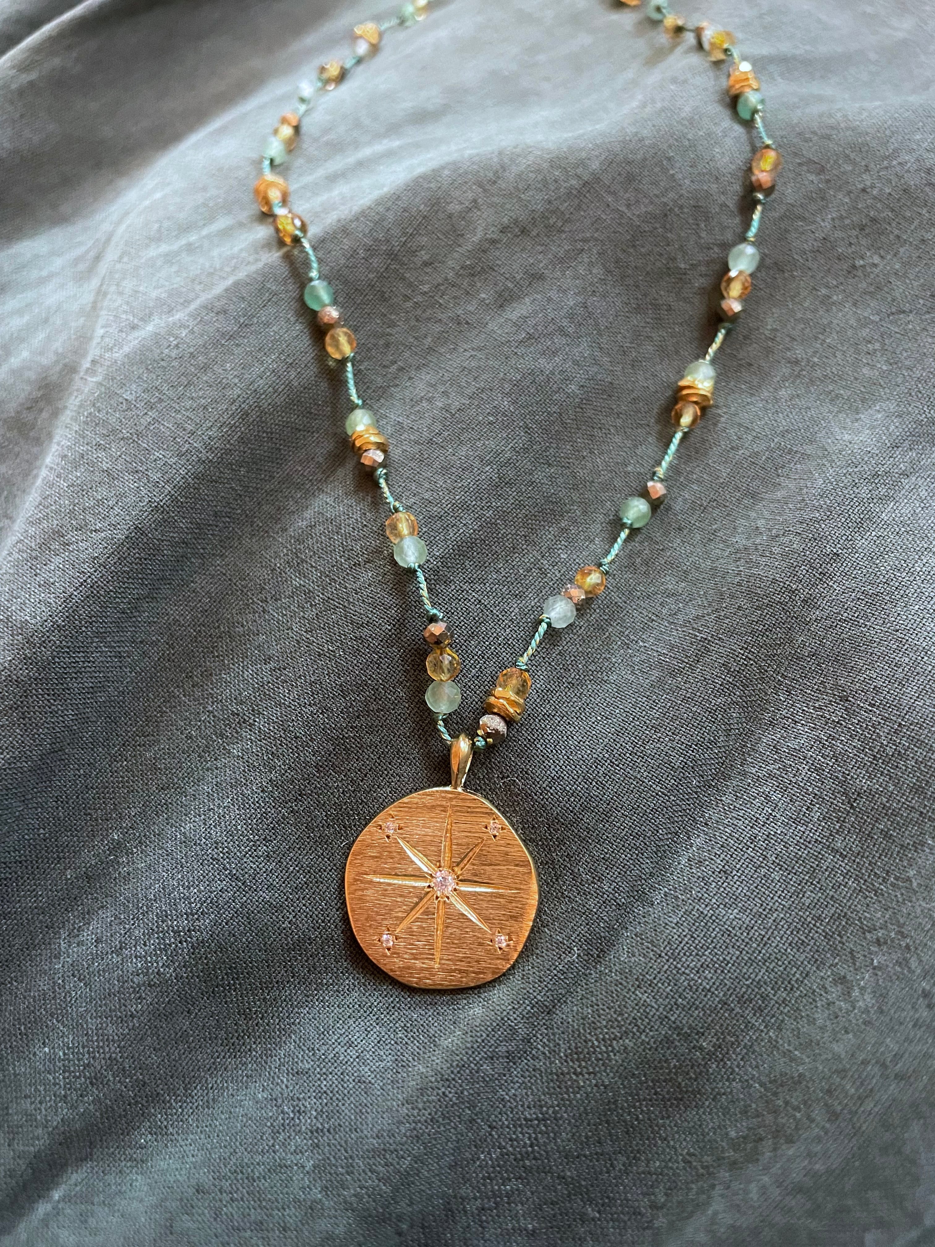 emerald thread necklace with sun medallion gold pendant by hanka in