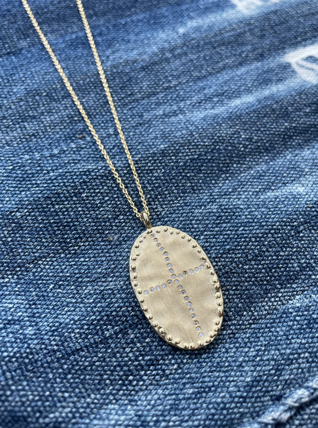 gold plated long necklace with gold pendant and white cubic zirconia stones louise hendricks bazile long necklace in white
